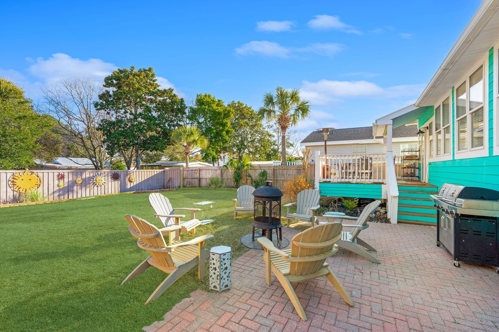 Fenced backyard with lawn and gas grill